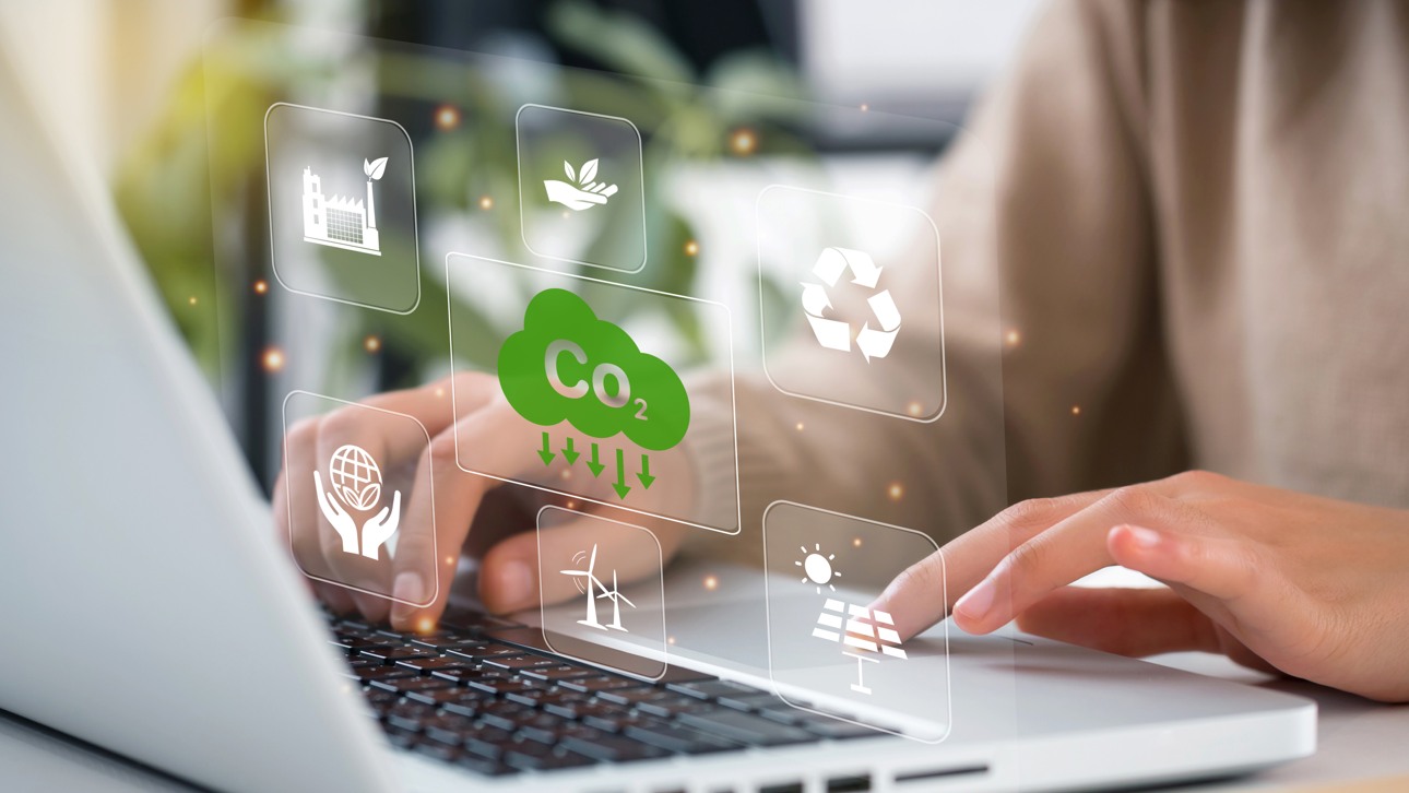 hands typing on a laptop with image of icons in the background